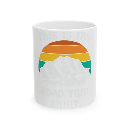 Mug with sunset, mountain, and RV graphic and text "ROAD TRIP SHIRT".