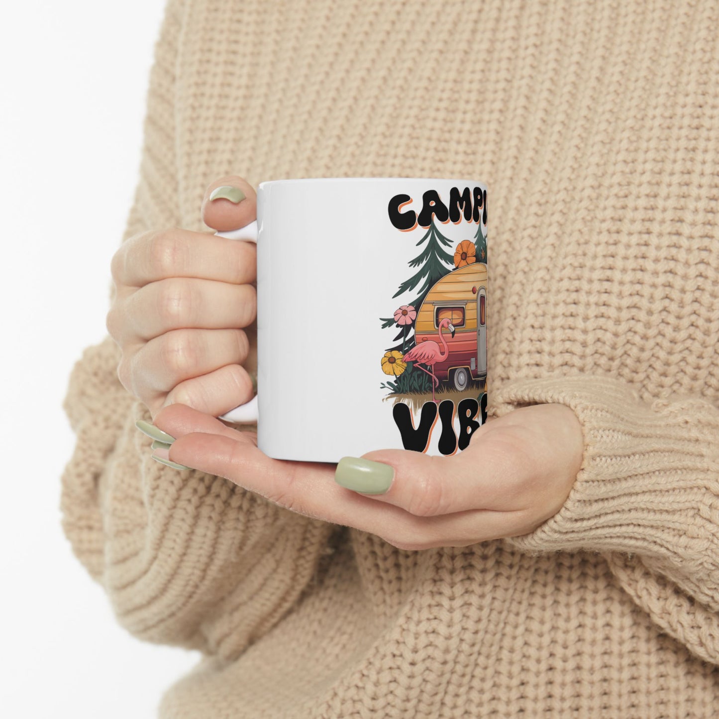 White mug with "CAMP VIBE" text, a retro camper, and a flamingo.