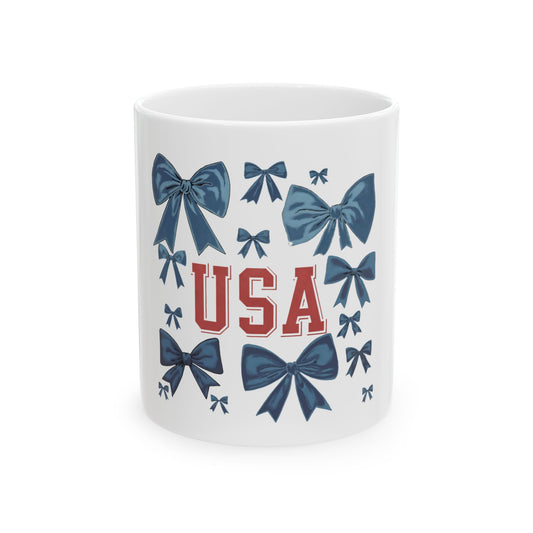 White mug with blue bows and red "USA" lettering.