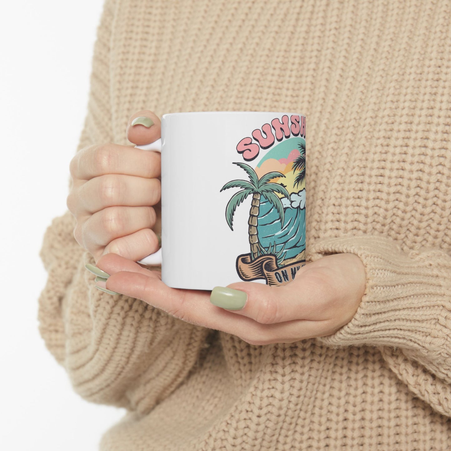 White mug with a colorful sunset beach design and "SUNSHINE ON MY MIND" text.