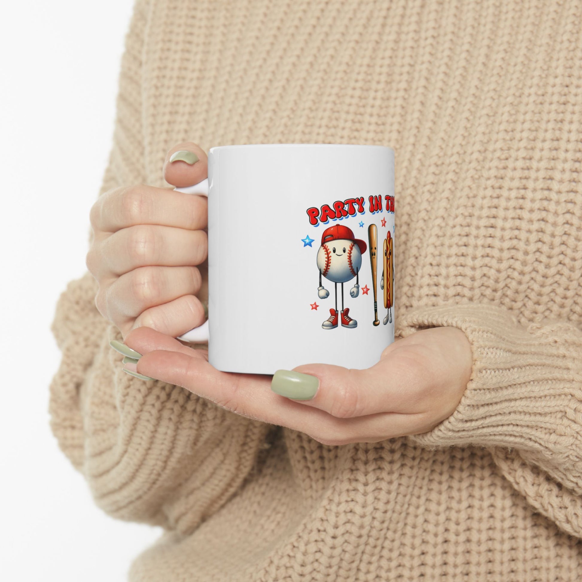 White mug with cartoon baseball, bat, and hot dog graphic, "PARTY IN TH" text.