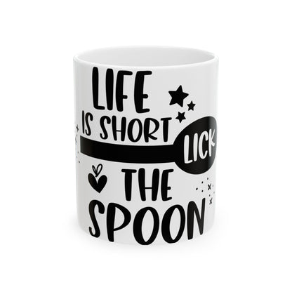 White mug with black text "LIFE IS SHORT LICK THE SPOON" and stars.