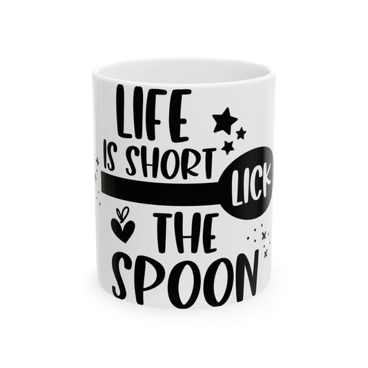 White mug with black text "LIFE IS SHORT LICK THE SPOON" and stars.