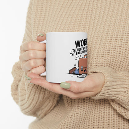 White mug with cartoon briefcase and text "WORK I THOUGHT WE WERE THE BARE MINIMUM".