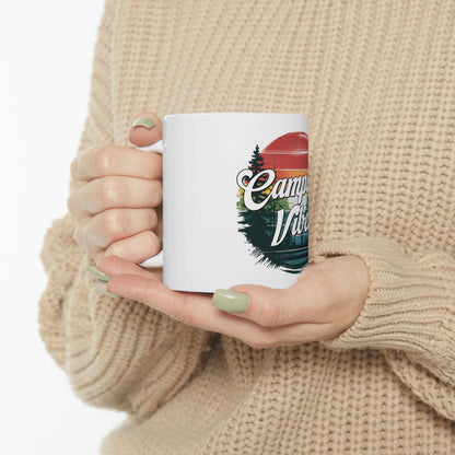 White mug with "Camping Vibes" text and a sunset forest graphic.