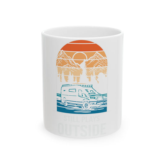 White mug with sunset mountain van scene and "STILL PLAYS OUTSIDE" text.