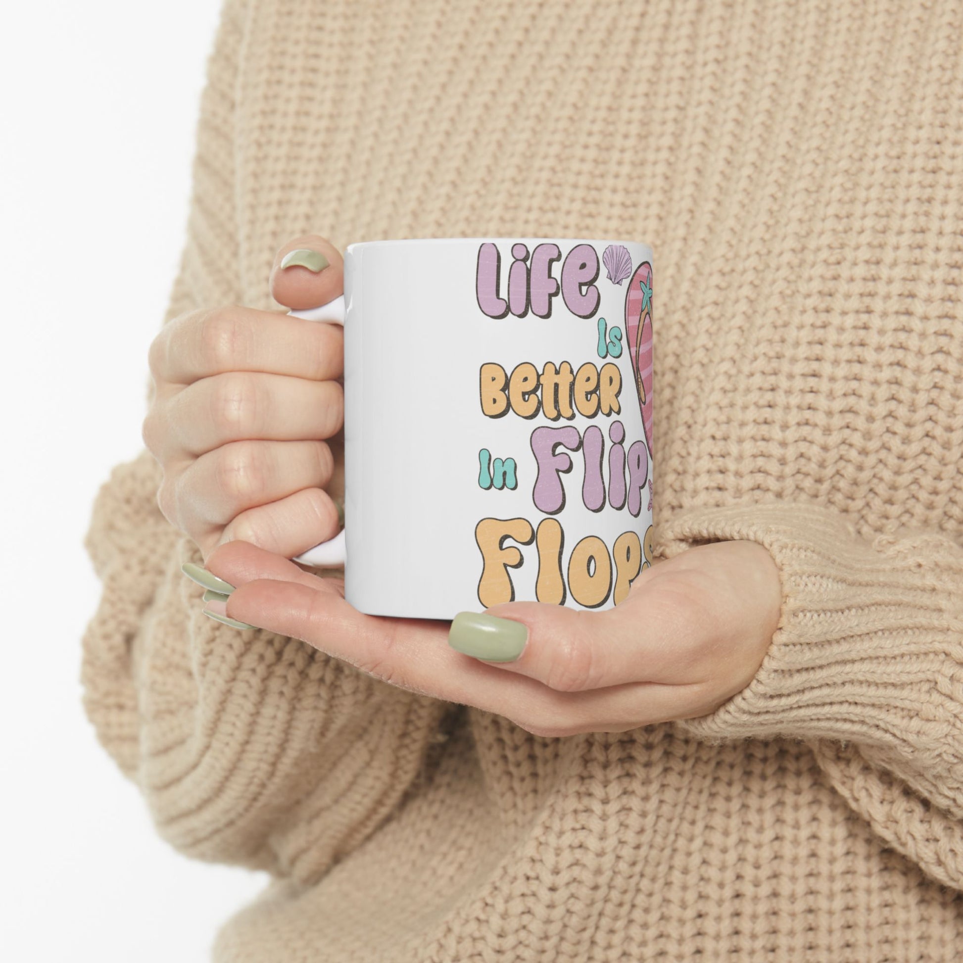 White mug with colorful text "Life is better in Flip Flops" and seashells.
