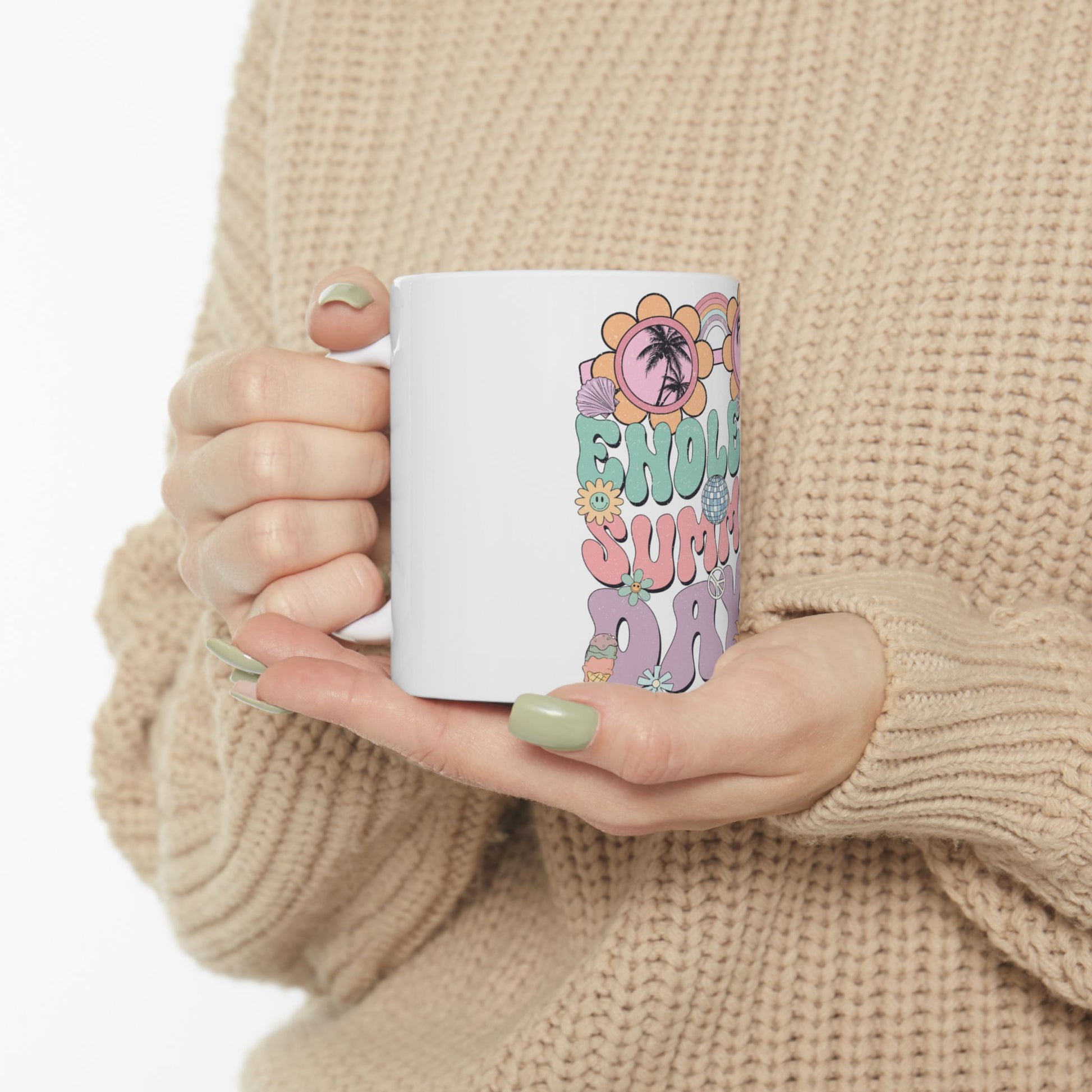 White mug with colorful "Hello Summer" text and graphics held by a person.