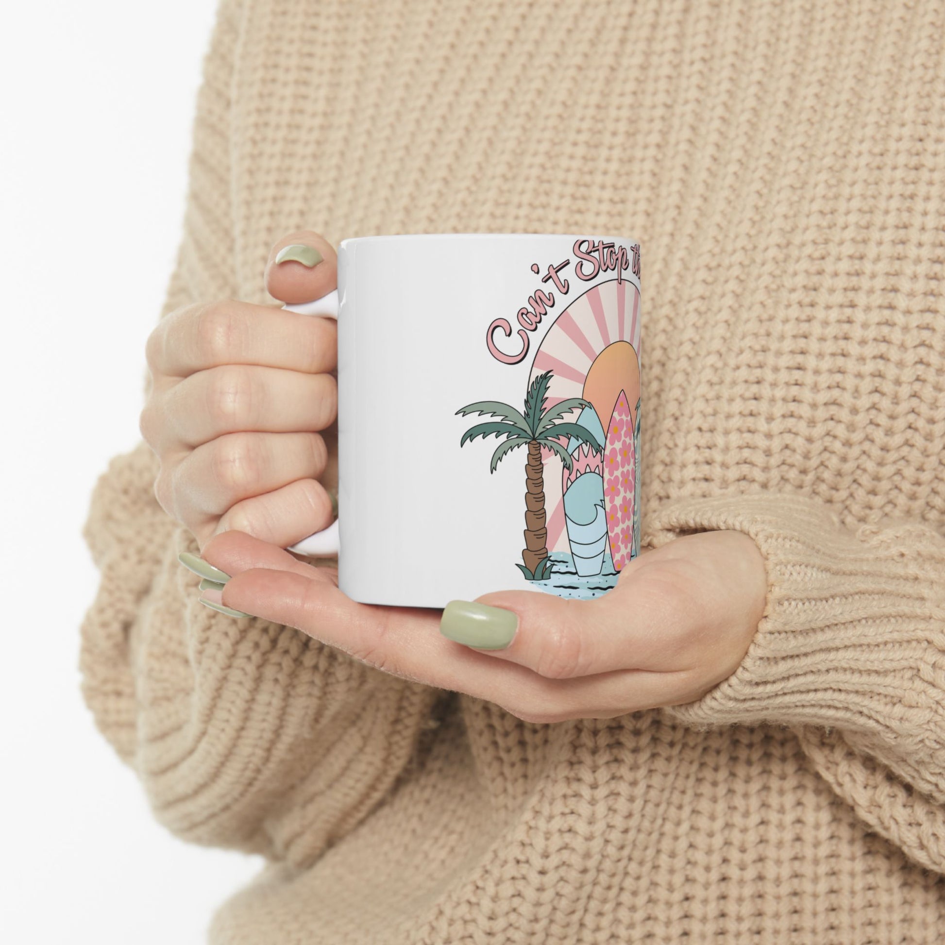 White mug with beach-themed design featuring a palm tree, surfboard, and sun.