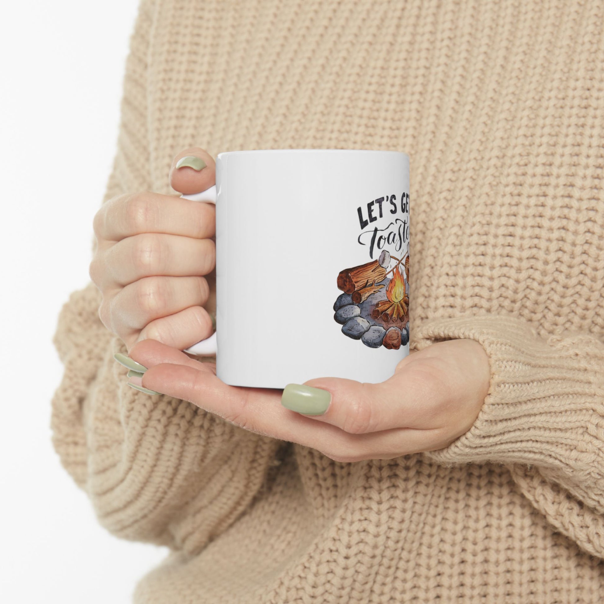 White mug with "Let's Get Toasted" text and campfire illustration.