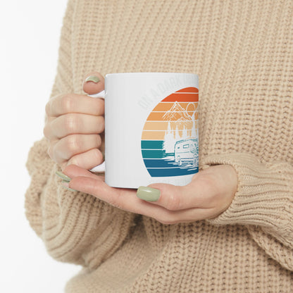 White mug with colorful camping sunset graphic and "On a dark, design..." text.