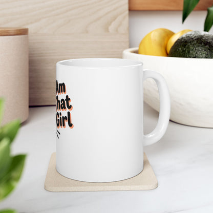 White mug with text "I Am That Girl" on a coaster.