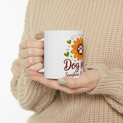 White mug with "Dog Mom Sunshine" text and paw print sunflower design.