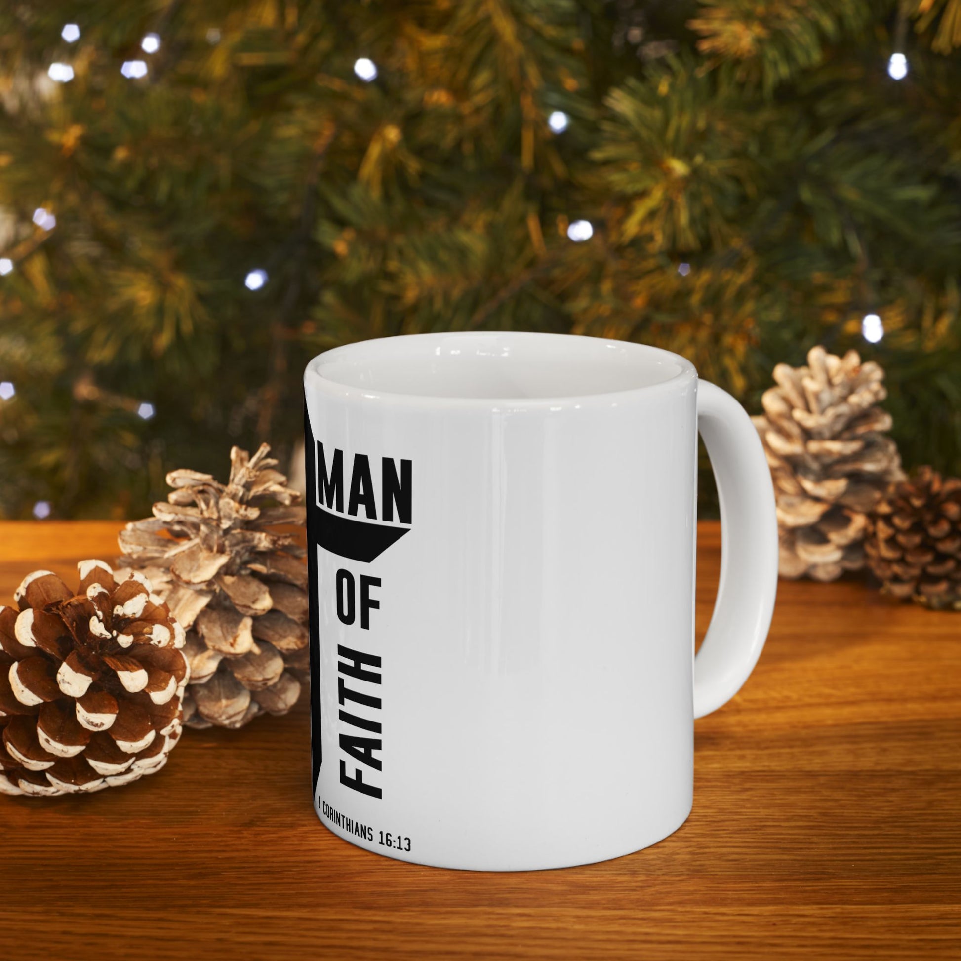 White mug with black text "MAN OF FAITH" and "2 Corinthians 16:13".
