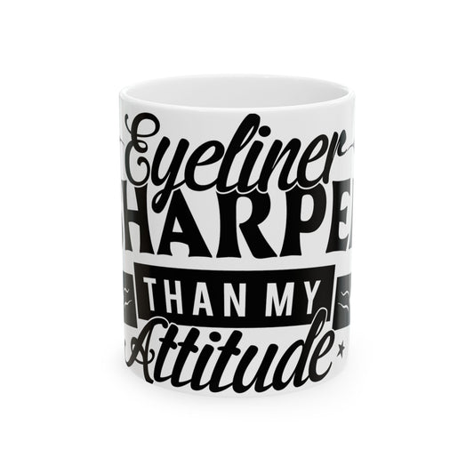 White mug with black text: "Eyeliner Sharper Than My Attitude"