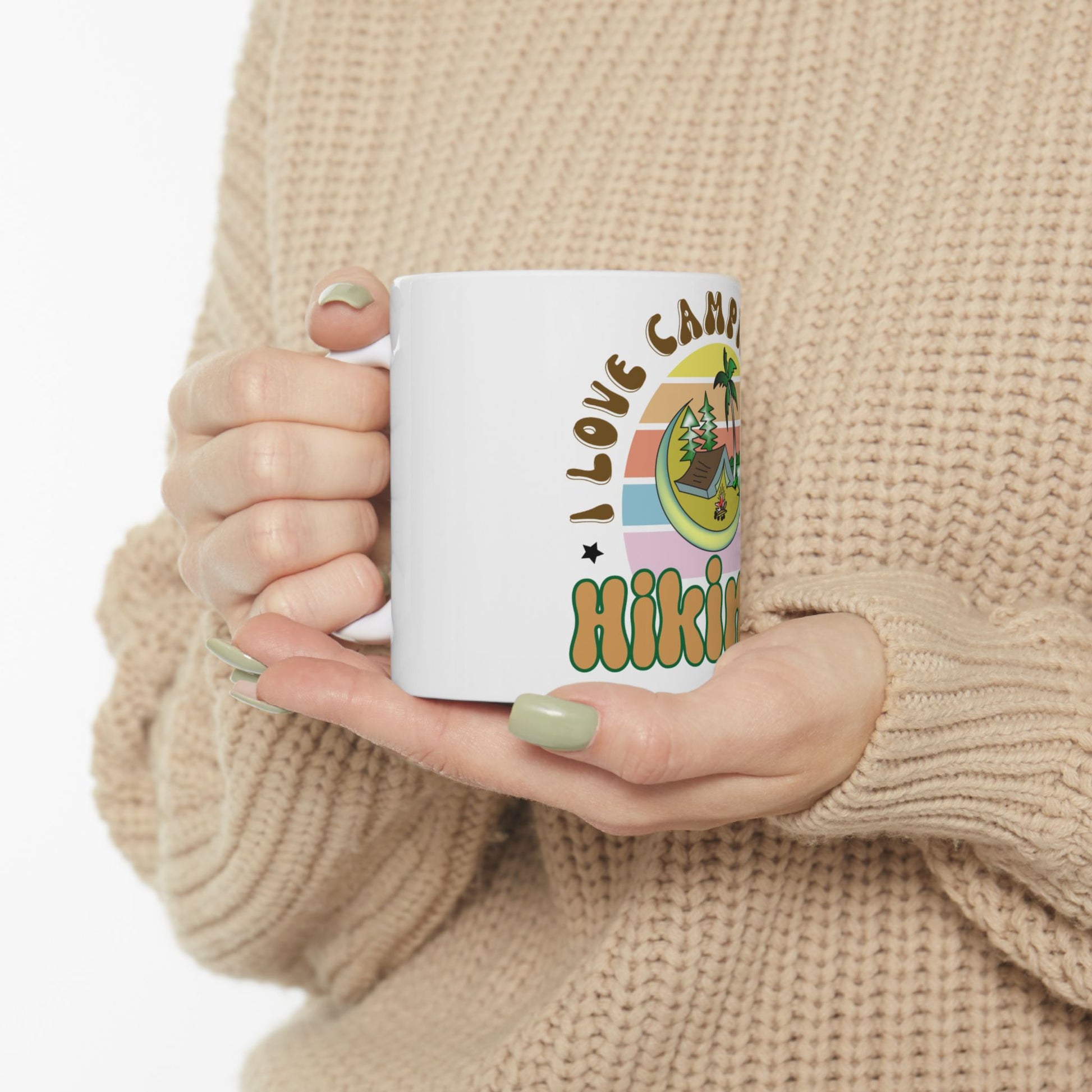 White mug with "I love camp hiking" text and colorful illustration.
