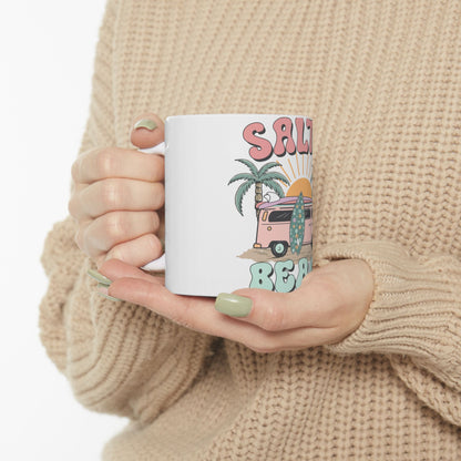 White mug with "Salt Beach" text, palm tree, and surfboard illustration.