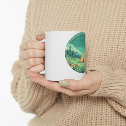 White mug with a whimsical camping scene illustration on its side.