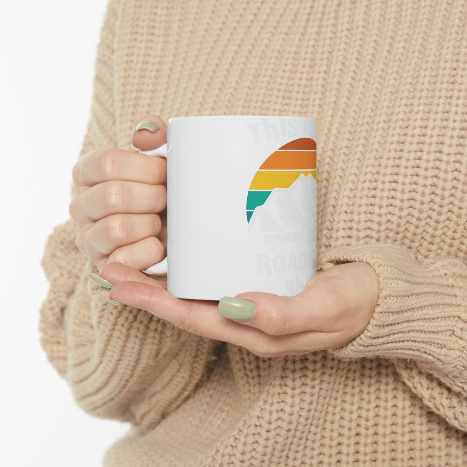 White mug with mountains, sunset, and "This is..." text.