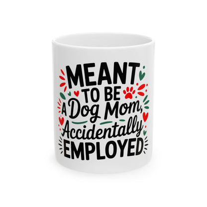 White mug with "Meant to be a Dog Mom, Accidentally Employed" text and paw prints.