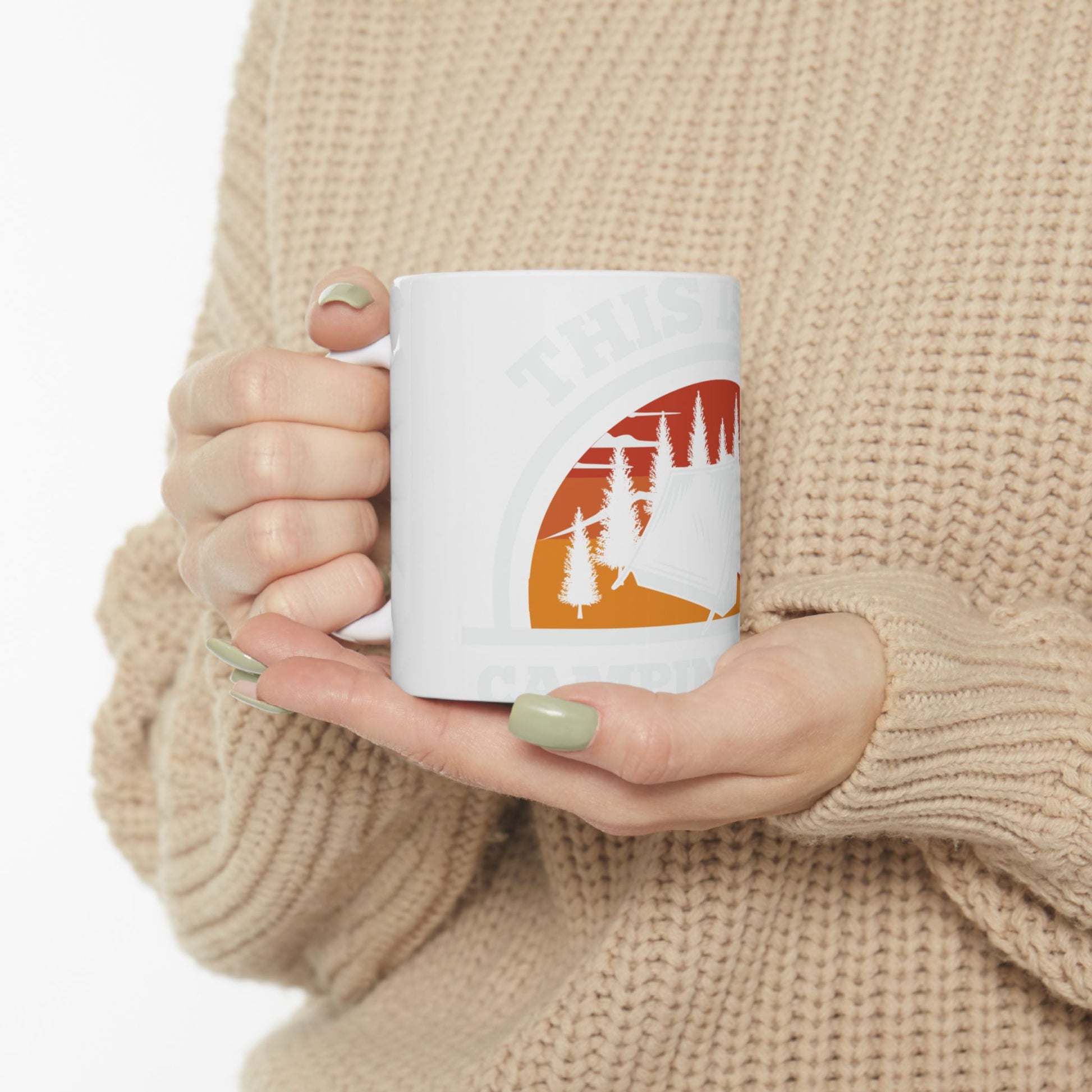 White mug with "THIS IS CAMPING" text and a sunset scene.