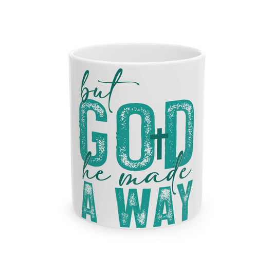 White mug with teal text "but GOD he made A WAY".