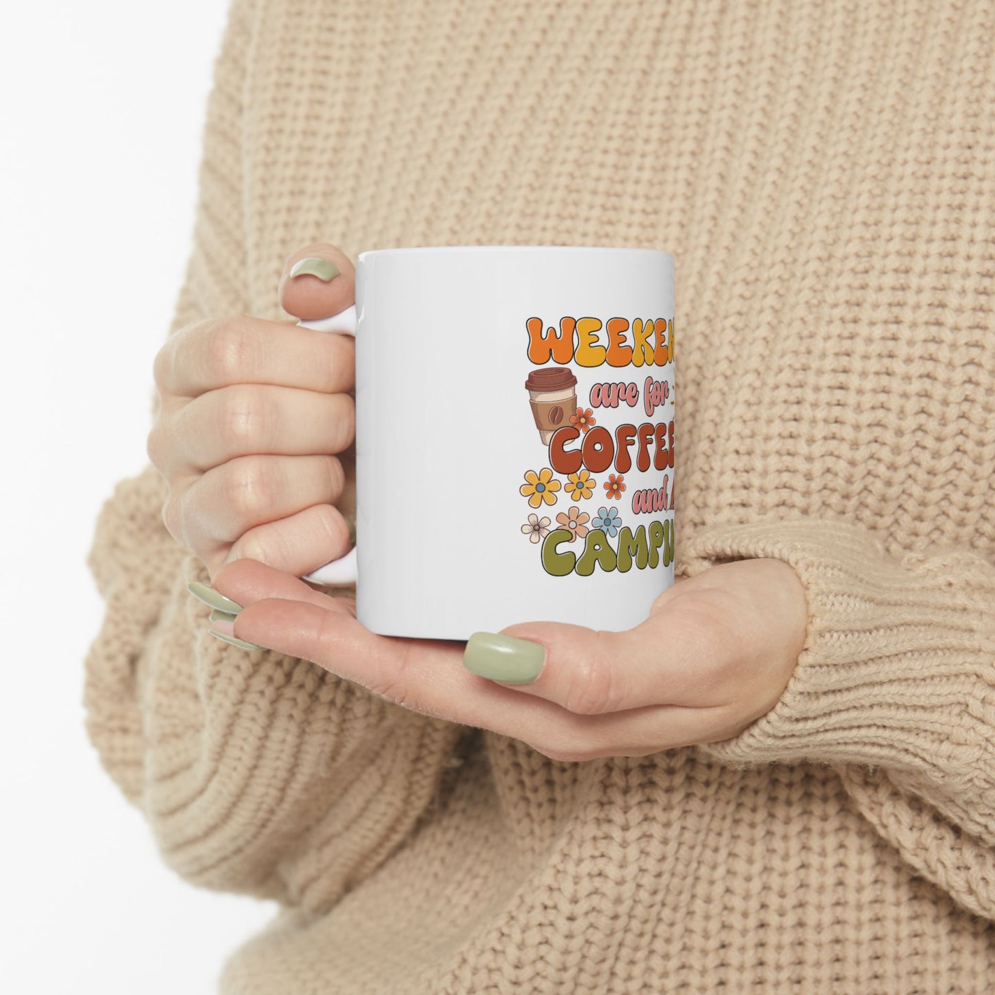 White mug with "Weekend are for coffee and camping" text and floral graphics.