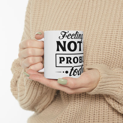 White mug with black text "Feeling Not Problem... today" held by hands.