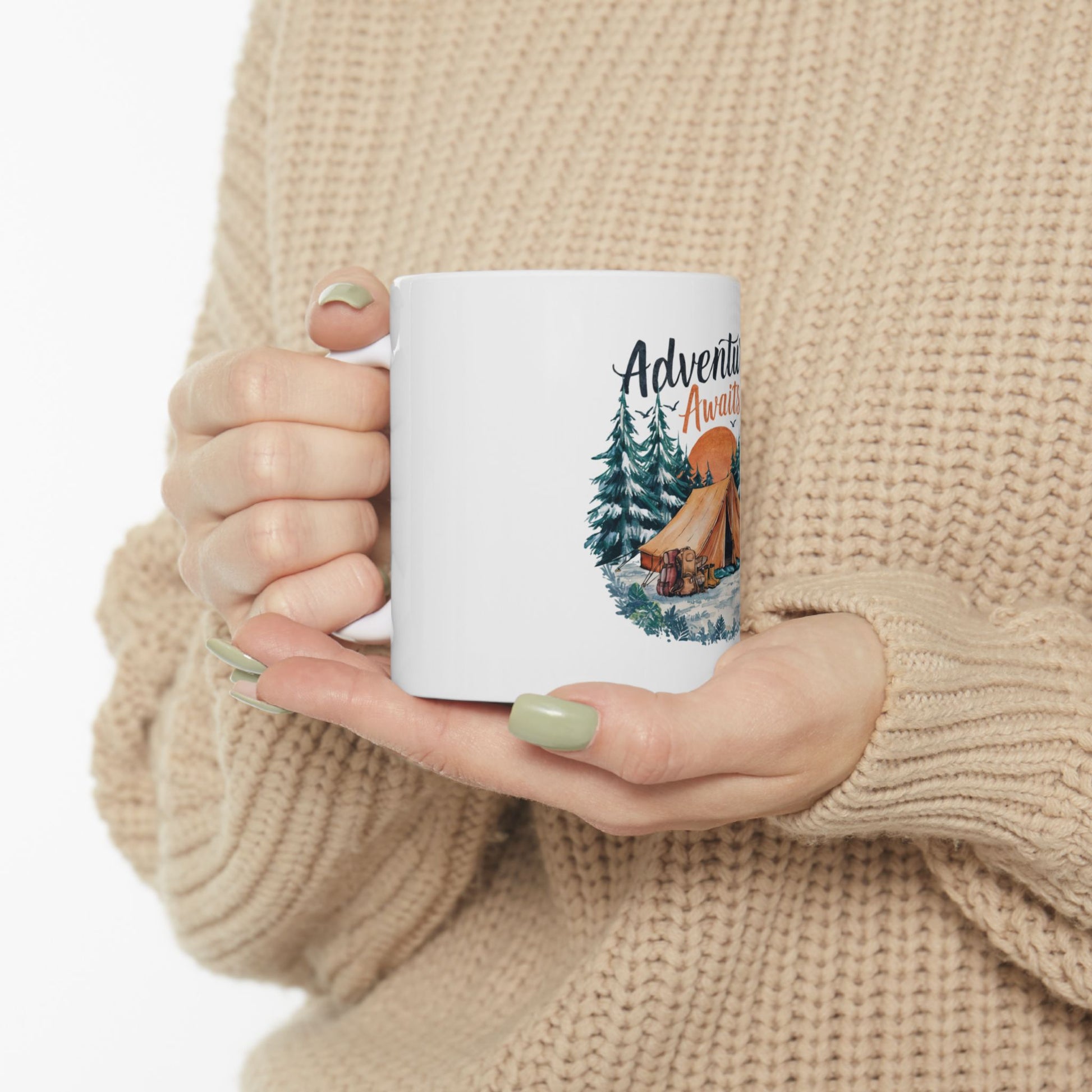 White mug with camping scene and "Adventure Awaits" text.