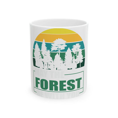 White mug with "May the Forest be with you" text and a stylized forest sunset graphic.