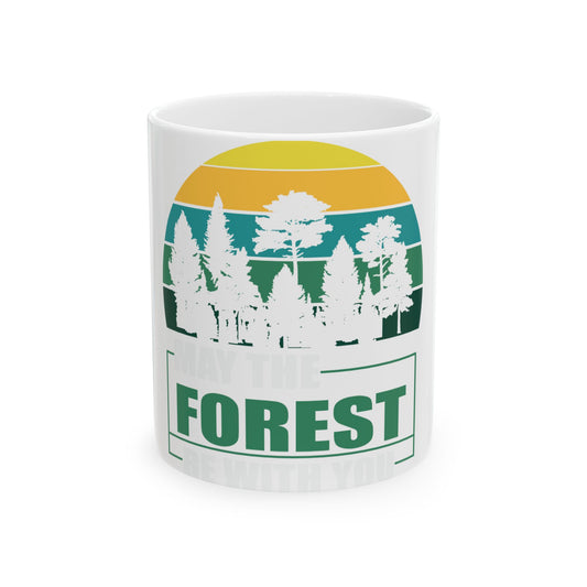 White mug with "May the Forest be with you" text and a stylized forest sunset graphic.