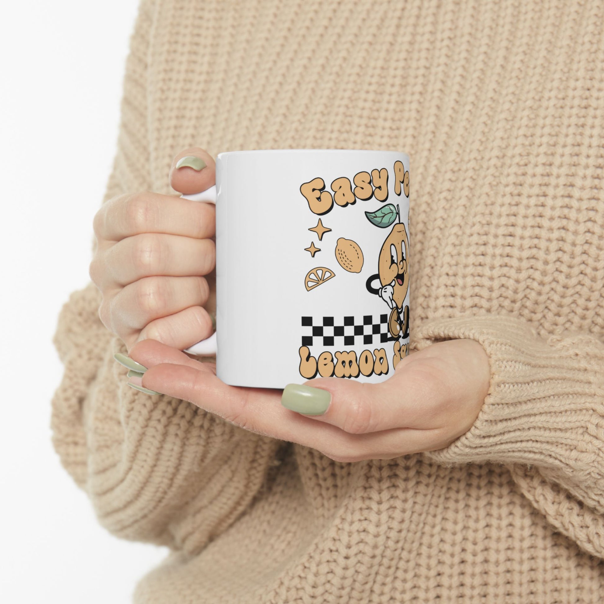 White mug with cartoon orange, checkered pattern, and "Easy Peasy Lemon Squeezy" text.
