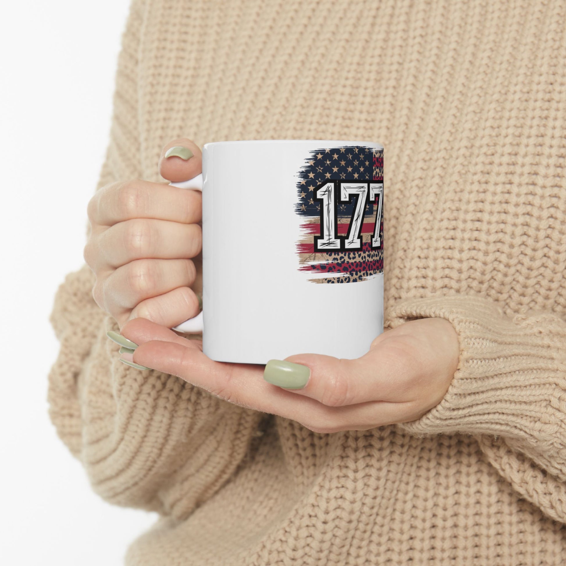 White mug with "1776" design featuring American flag and leopard print.