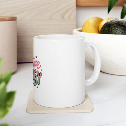 White mug with "Creative Energy" text and wavy lines on a coaster.