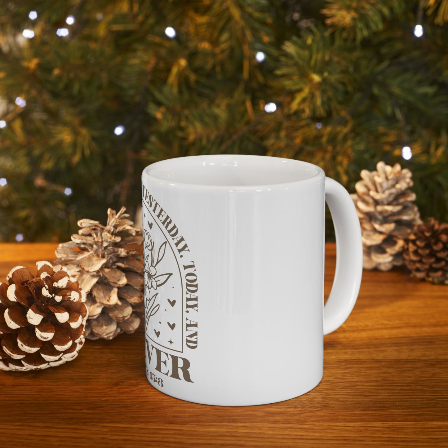 White mug with "Yesterday, Today, and Forever" text, surrounded by pinecones.