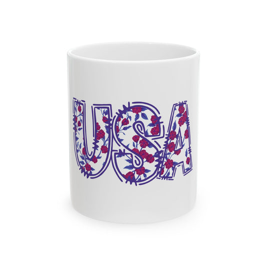White mug with "USA" in a floral pattern of blue letters and red flowers.