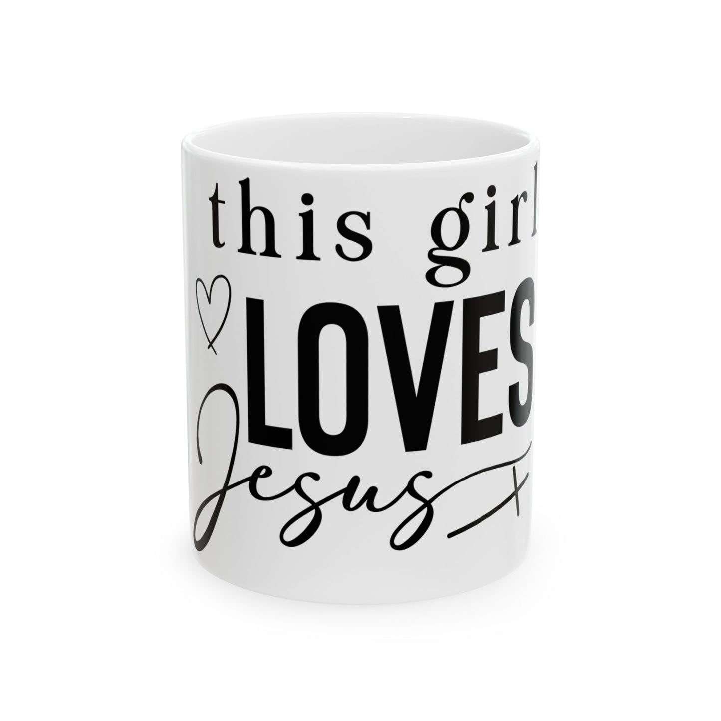 White mug with "This girl LOVES Jesus" in black lettering.