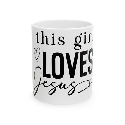White mug with "This girl LOVES Jesus" in black lettering.