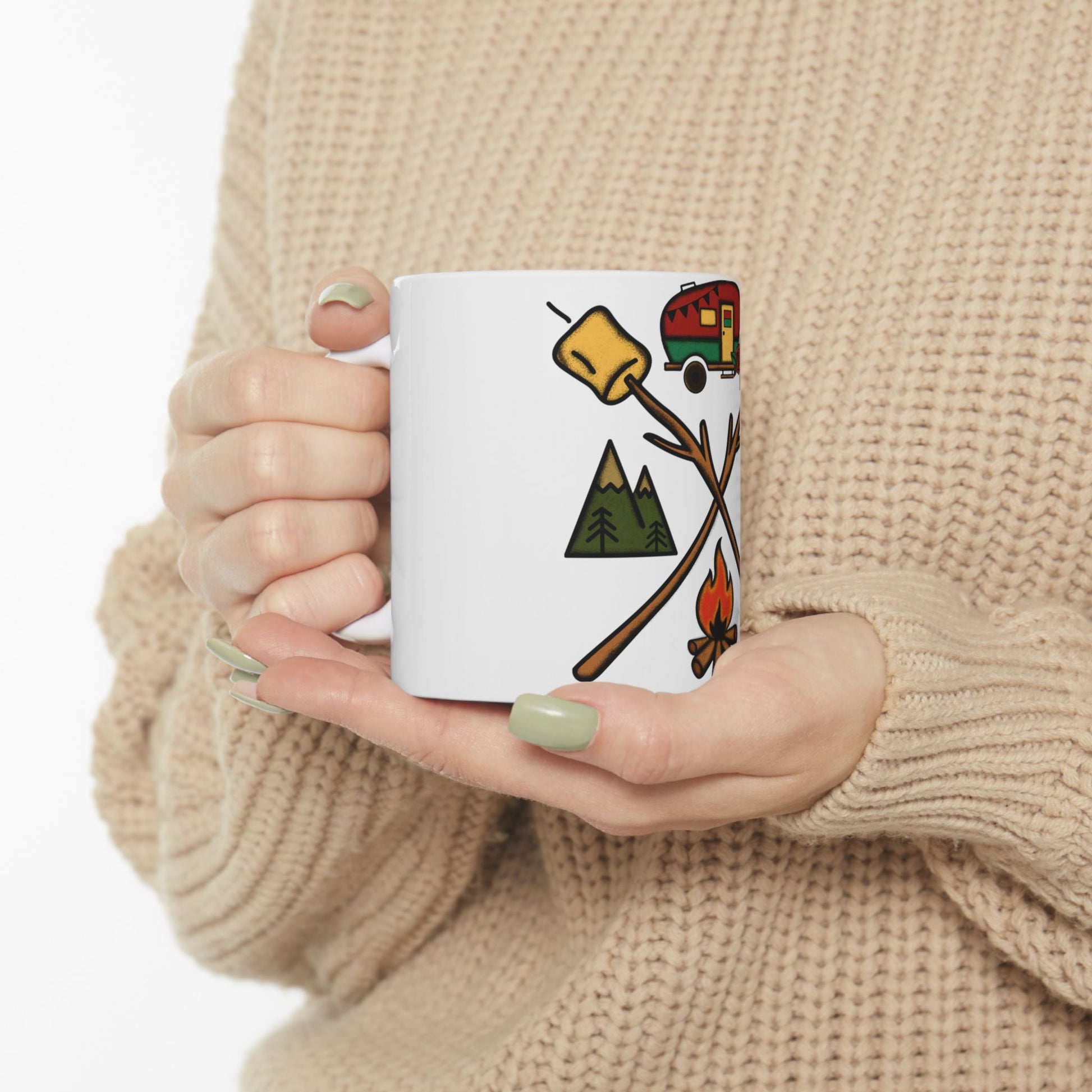 White mug with camping icons: campfire, marshmallows, tent, and trees.