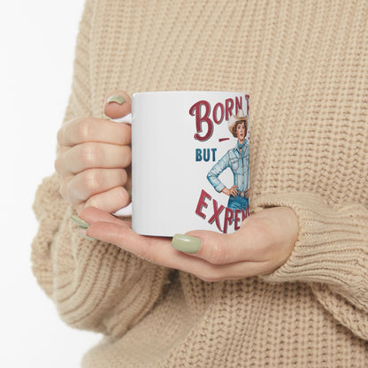 White mug with "Born Texas But Expensive" text and cowboy illustration.