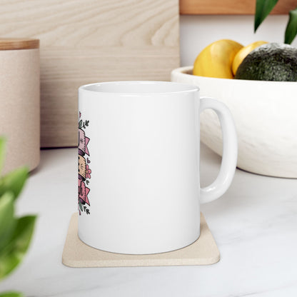 White mug with "Be Kind" text and floral accents on a coaster.